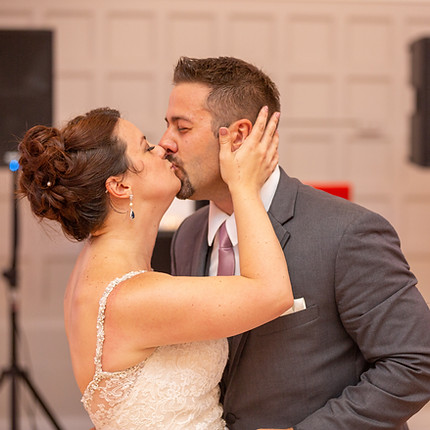A couple kisses in the Grand Ballroom